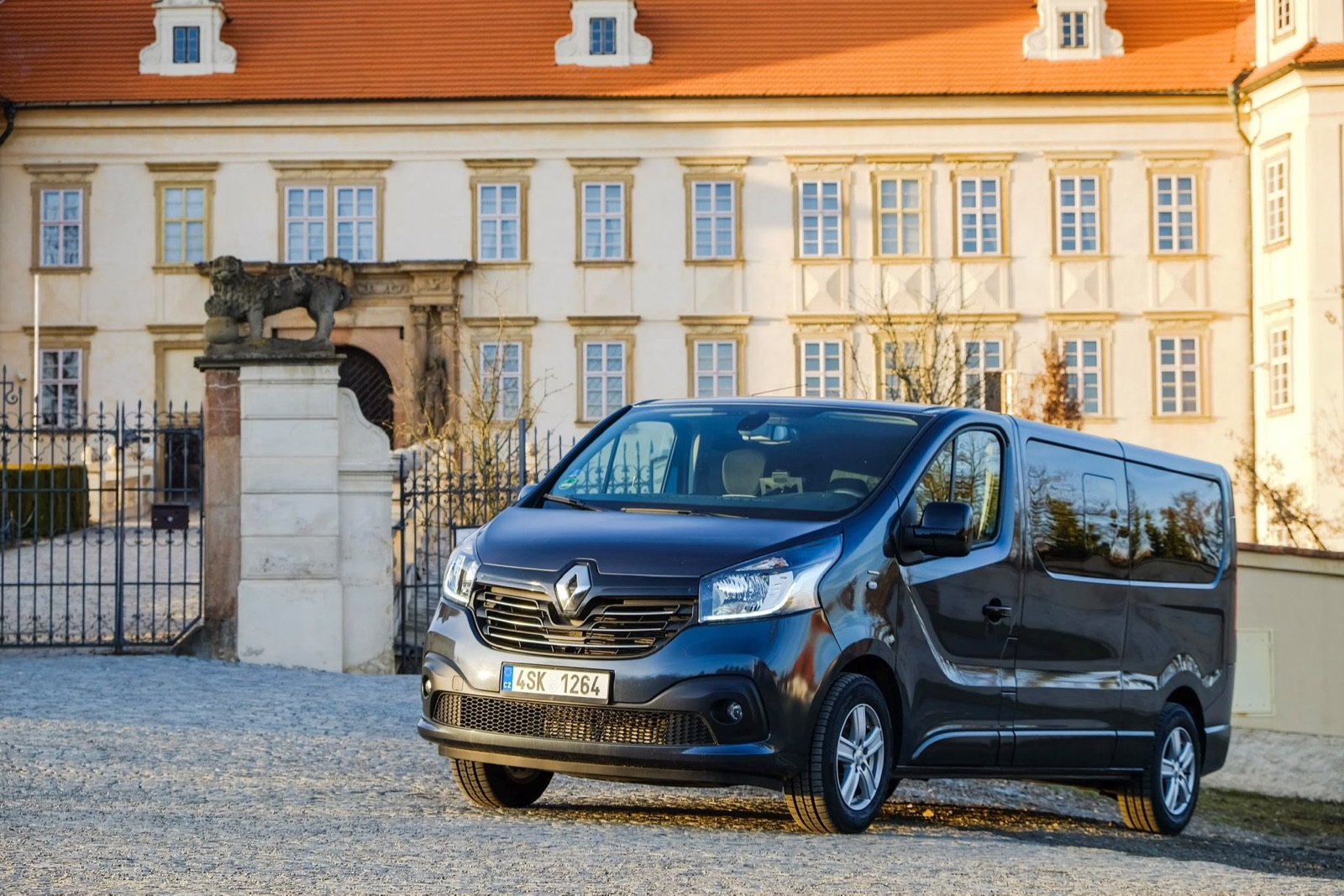 Passenger van photographed outside a historic building